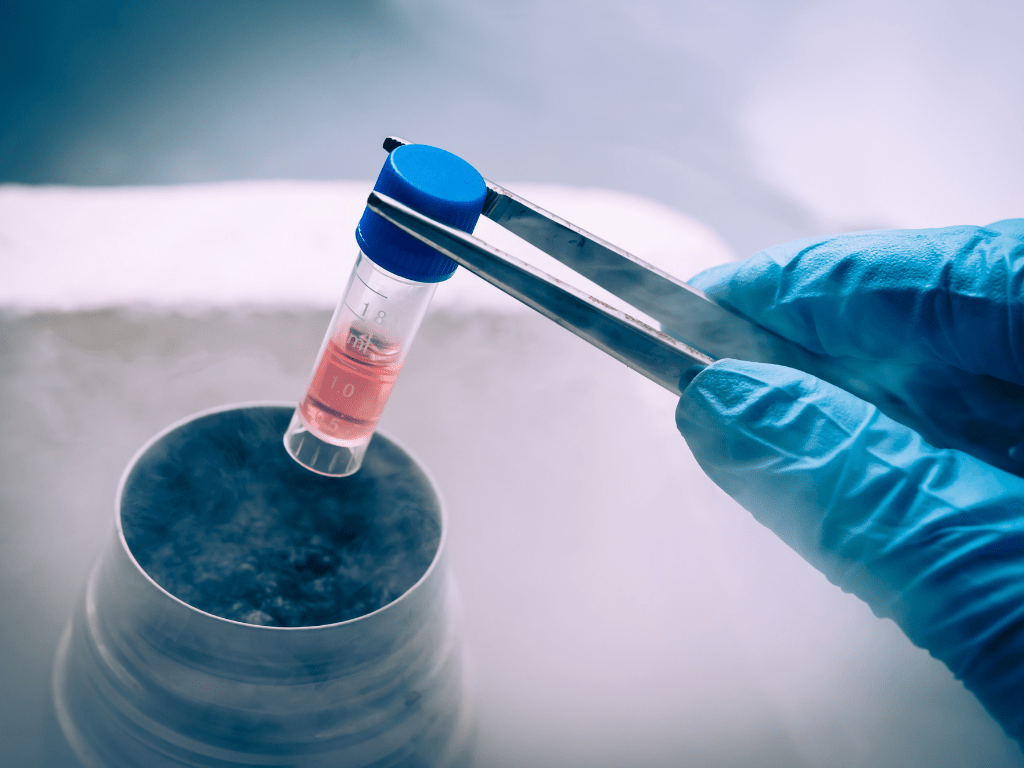 Medical professional holding a vial containing a sample for autologous stem cell therapy